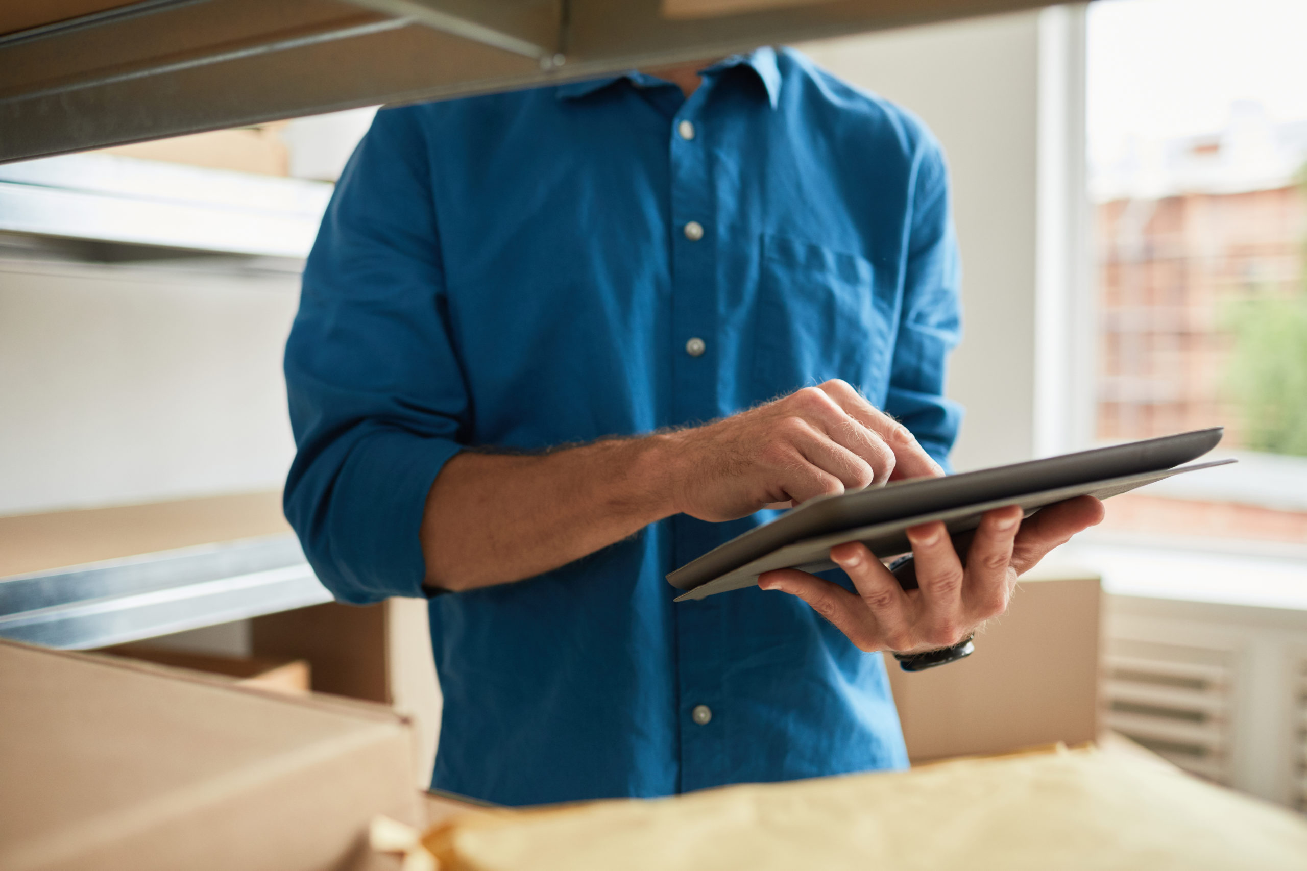 Man Managing Stock Inventory Close Up